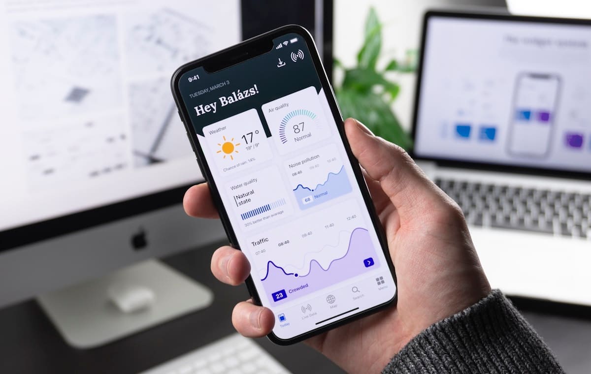 Mobile app interface being reviewed on a phone